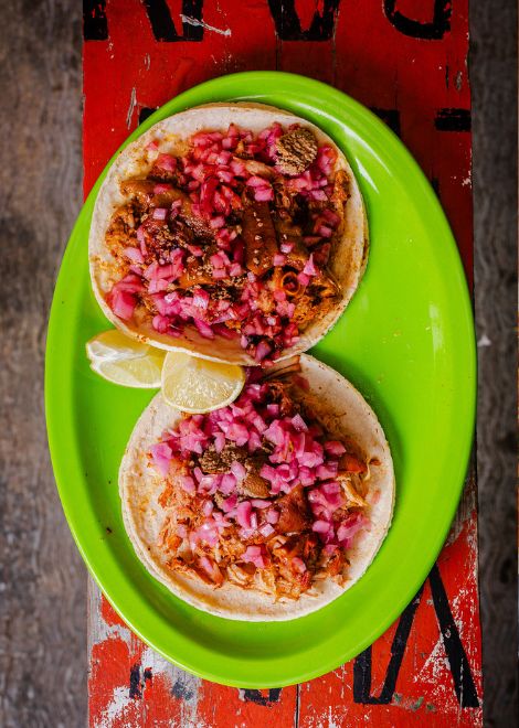 Slow-cooked cochinita pibil taco with onions steeped in sour orange