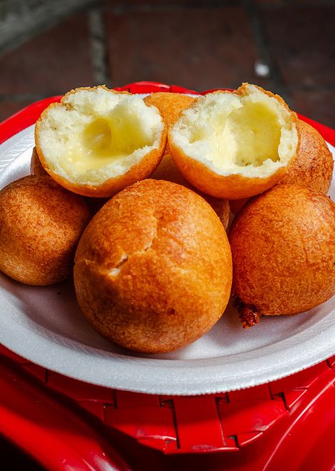 Crunch into freshly fried buñuelos, golden outside and fluffy inside.