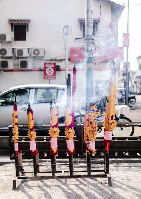 Giant burning incense sticks outside the Goddess Of Mercy Temple