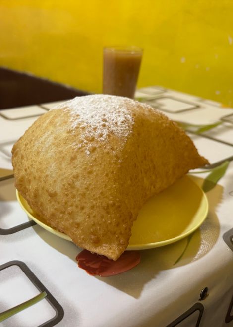 Fried pastel cheese dusted with a little sugar