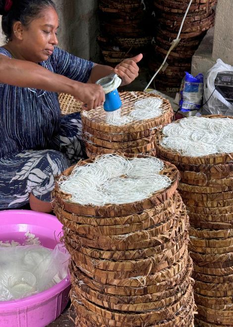 Delicate string hoppers made by hand and layered into baskets.