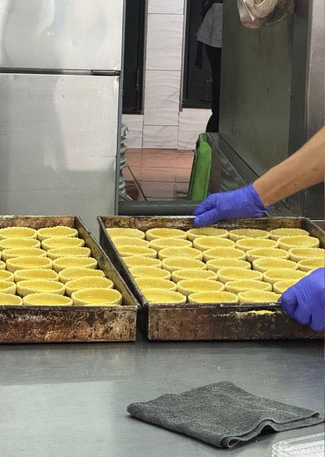 Rows of egg tarts, ready for the oven.