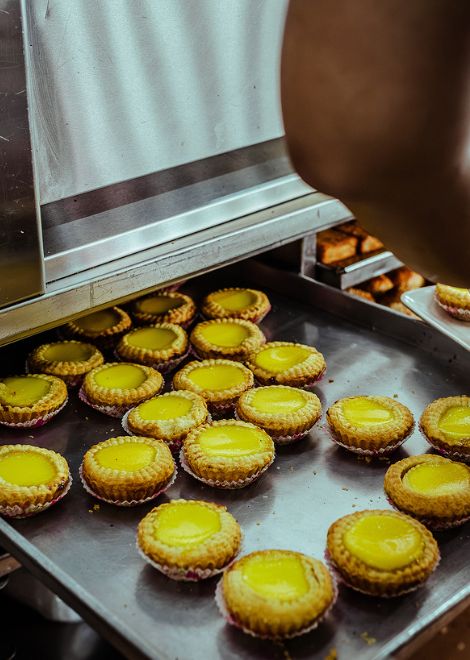 Rows of egg tarts, ready for the oven.