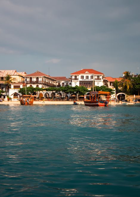 Cruise back to Stone Town as the sun slips below the horizon.