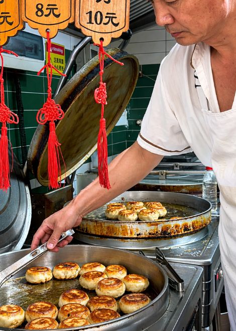 Beef and spring onion doornail pies, crisped in a giant pan.