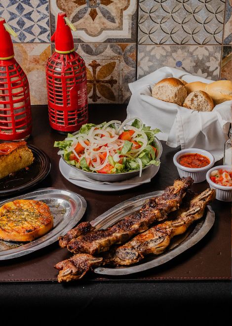 Beef ribs, grilled provoleta, and a classic mixed salad served in one of Buenos Aires' historic parrillas