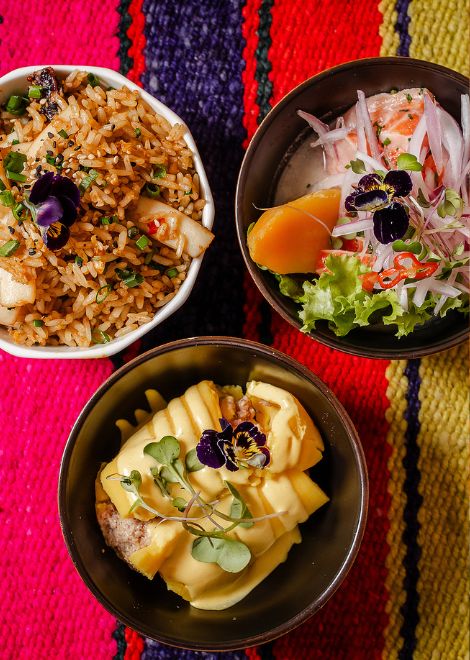 A trio of Peruvian favourites: seafood arroz chaufa, vibrant causa limeña, and fresh trout ceviche from the waters of the Andes
