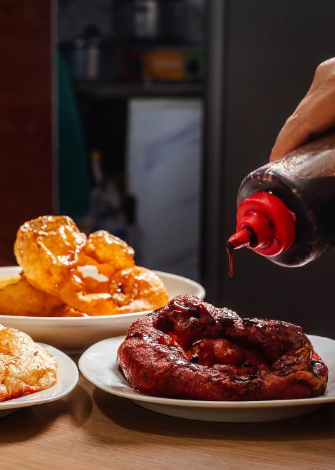 Golden, crisp, and drizzled with syrup, picarones are Peru's answer to the doughnut