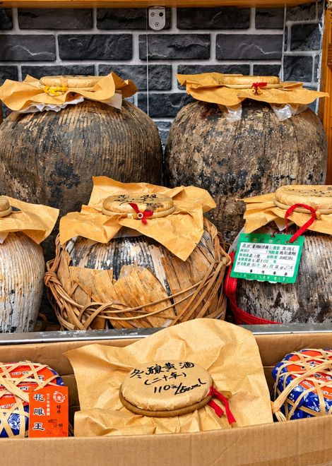 Clay jars of aged rice wine, sealed and ready to pour.