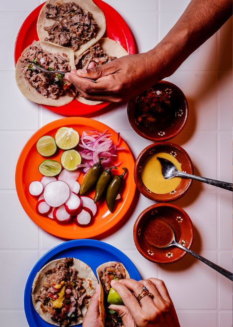 Slow-cooked, tender carnitas tacos with a squeeze of lime