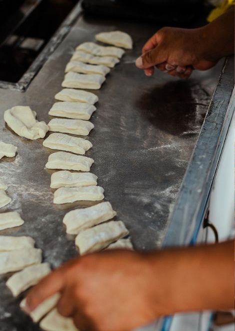Hand-preparing the cassava dough for traditional yuquitas.