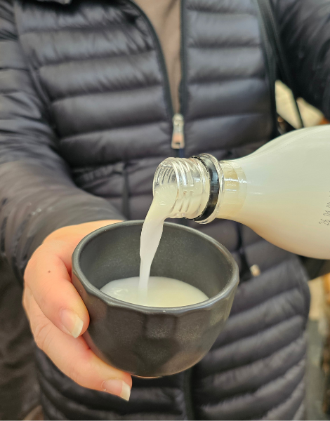 Your host pours a Korean makgeolli rice wine