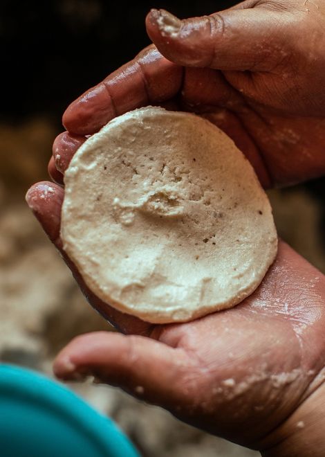 Hand-shaping fresh corn pupusas the Salvadoran way.