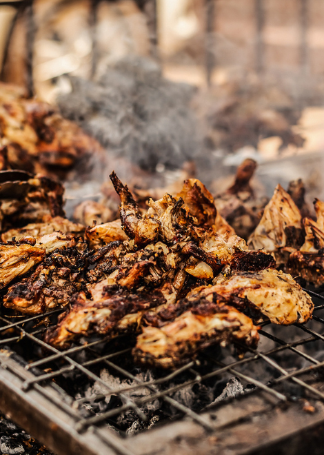 Smoky kuku grilled chicken over charcoal