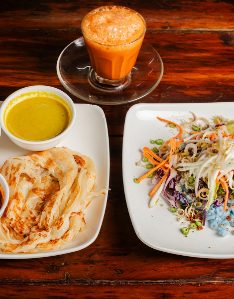 Flaky roti dipped in rich curries