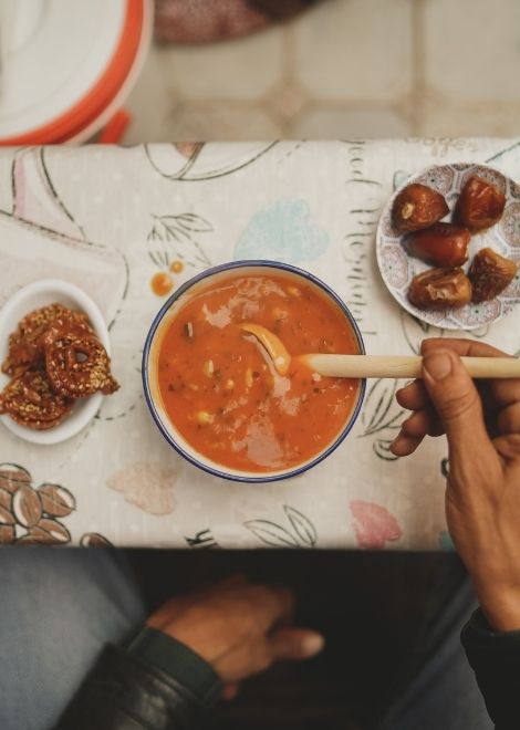 A soothing bowl of harira with local pastries and dates