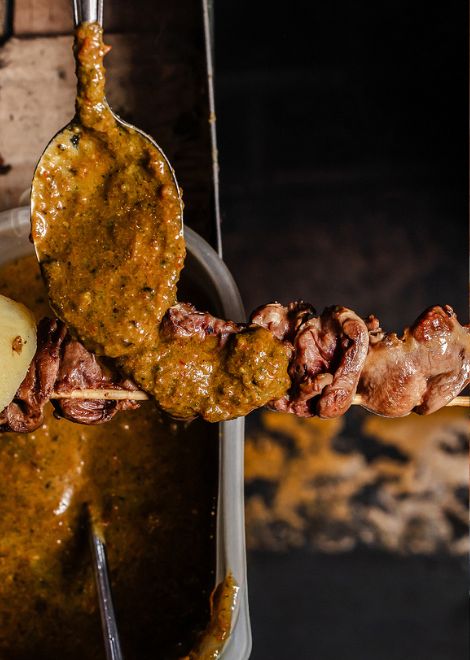 Tender grilled chicken heart anticuchos with traditional uchucuta chilli sauce.