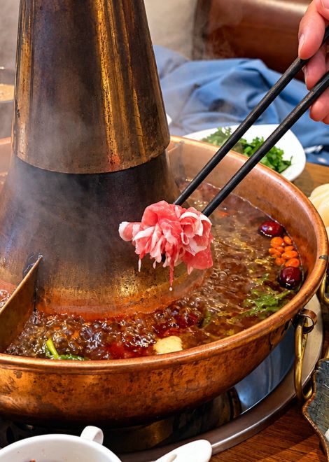 Paper-thin lamb, swished through bubbling broth.
