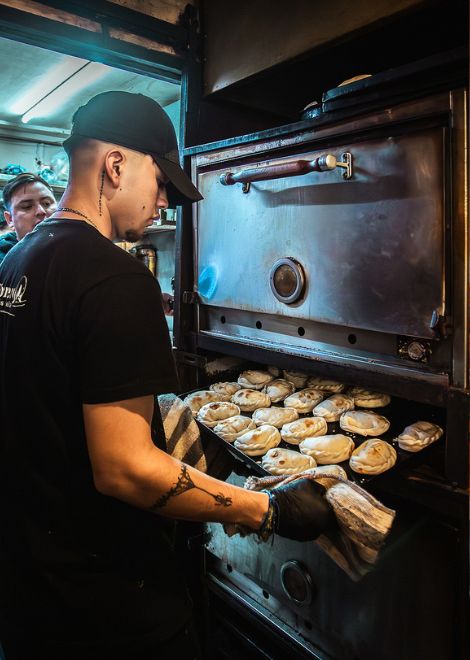 Rows of freshly folded empanadas await the oven