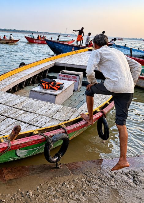 Boats waiting at the edge of the river.