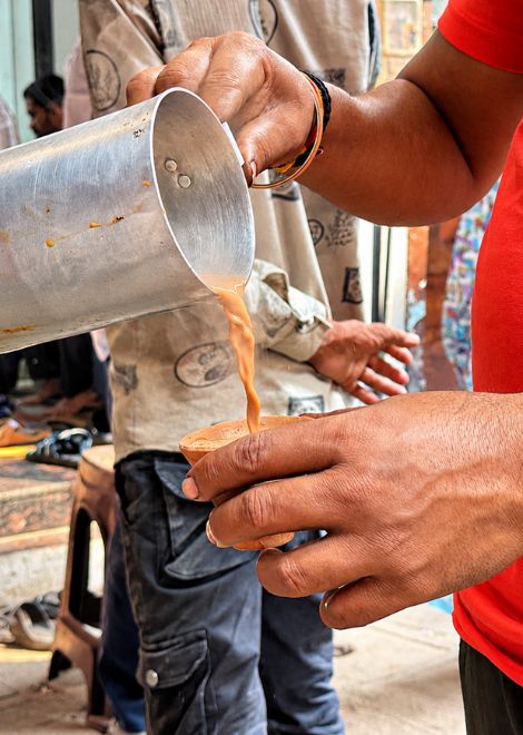 Masala chai poured from a height, street-style.