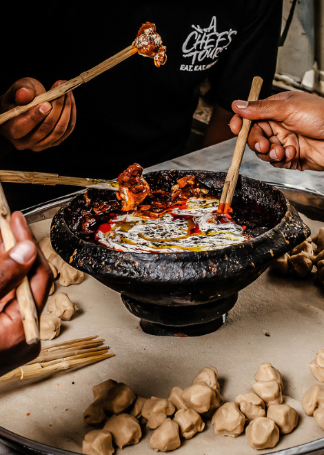 Tihilo, roasted barley flour dough dipped into rich Ethiopian lamb stew