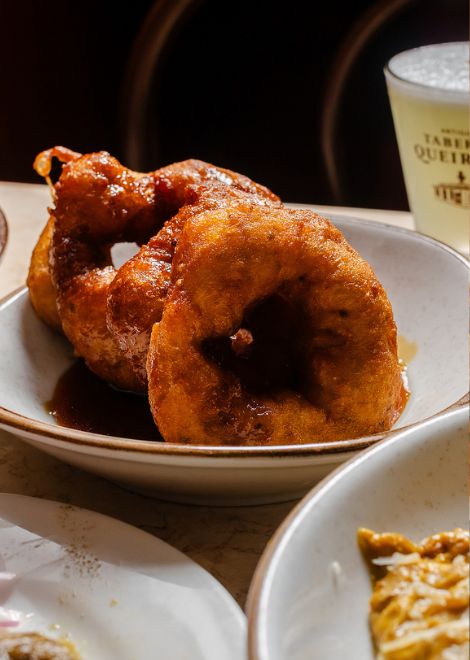 Freshly fried picarones, Peru's iconic pumpkin and sweet potato doughnuts.