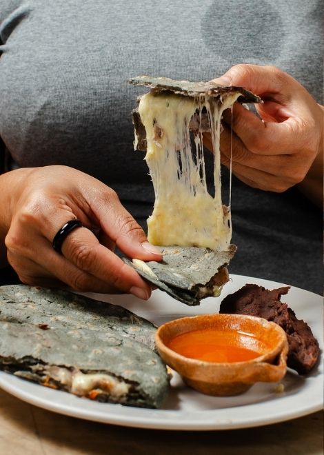 Warm tortillas con queso, handmade with fresh Guatemalan cheese.