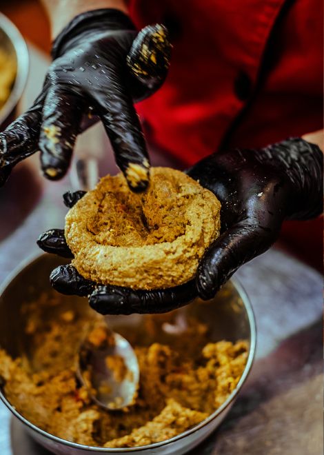 Hand-shaping traditional bolón de queso.