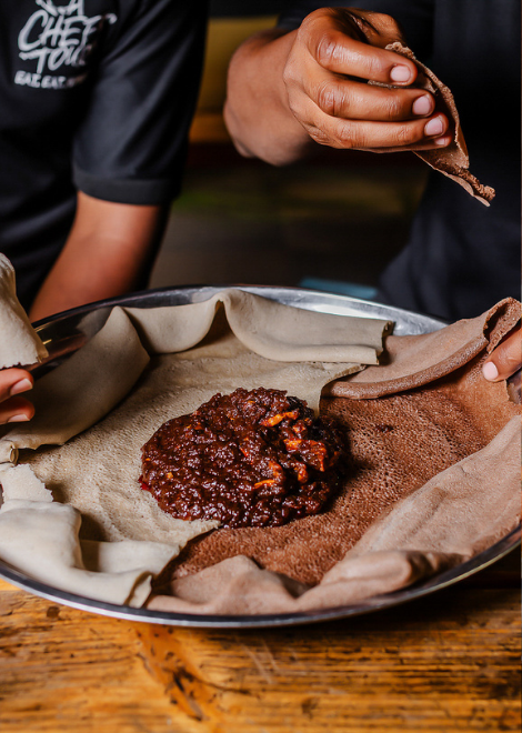 Duba quanta, dried squash stew with tangy injera