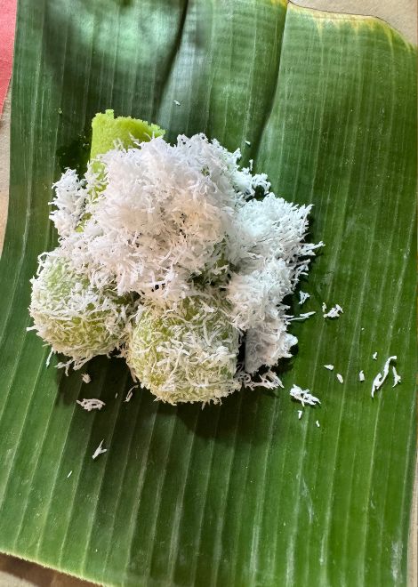 Soft klepon bursting with molten palm sugar.