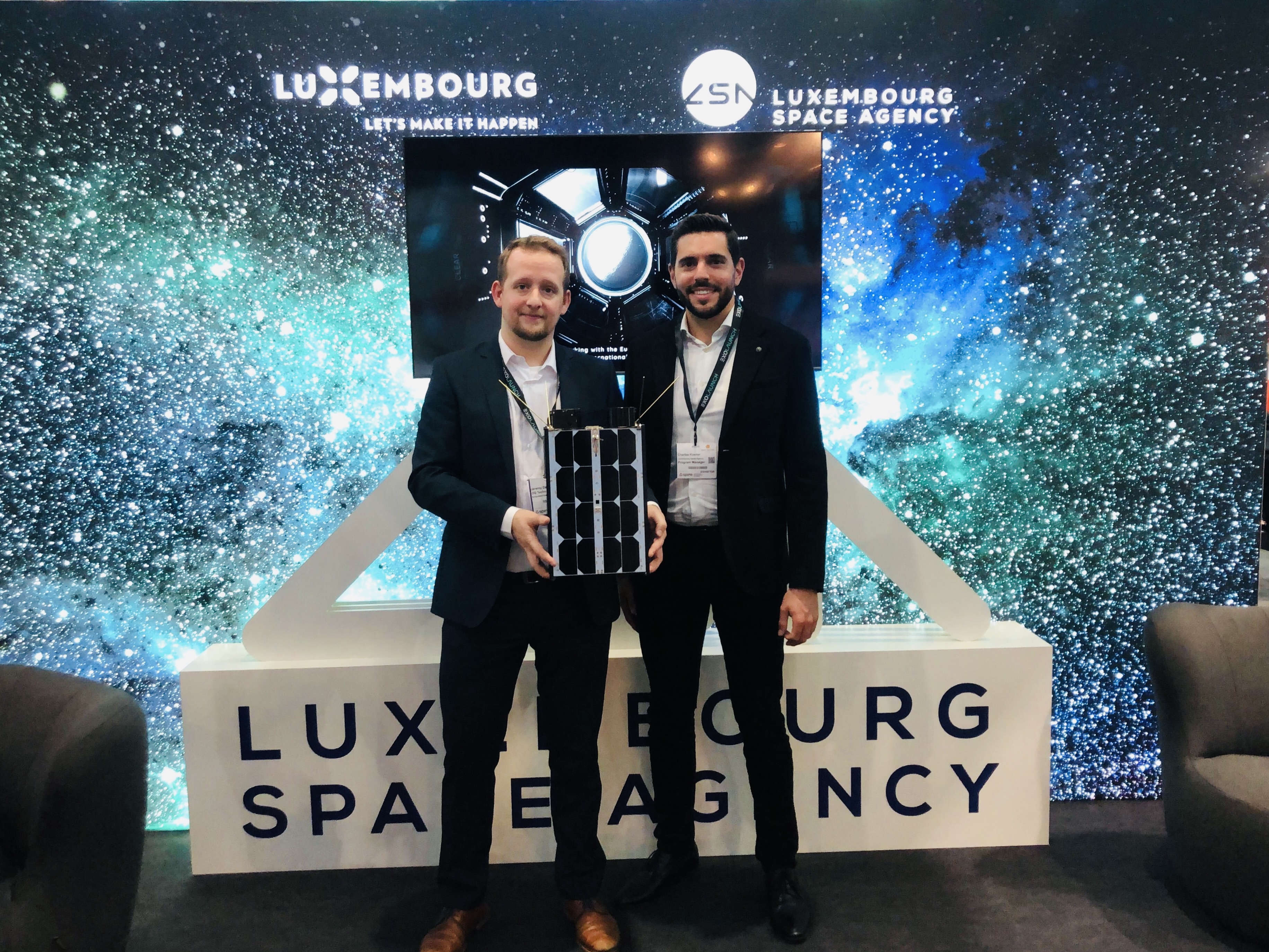 Jeremy Dracis (OQ Technology) & Charles Koener (Luxembourg Space Agency) with MACSAT model at the Space Tech Europe event in Bremen