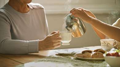 Person pouring tea from teapot