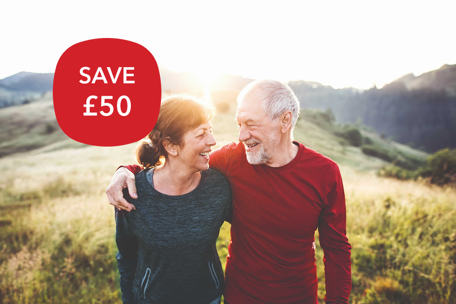A couple walking on a hill.