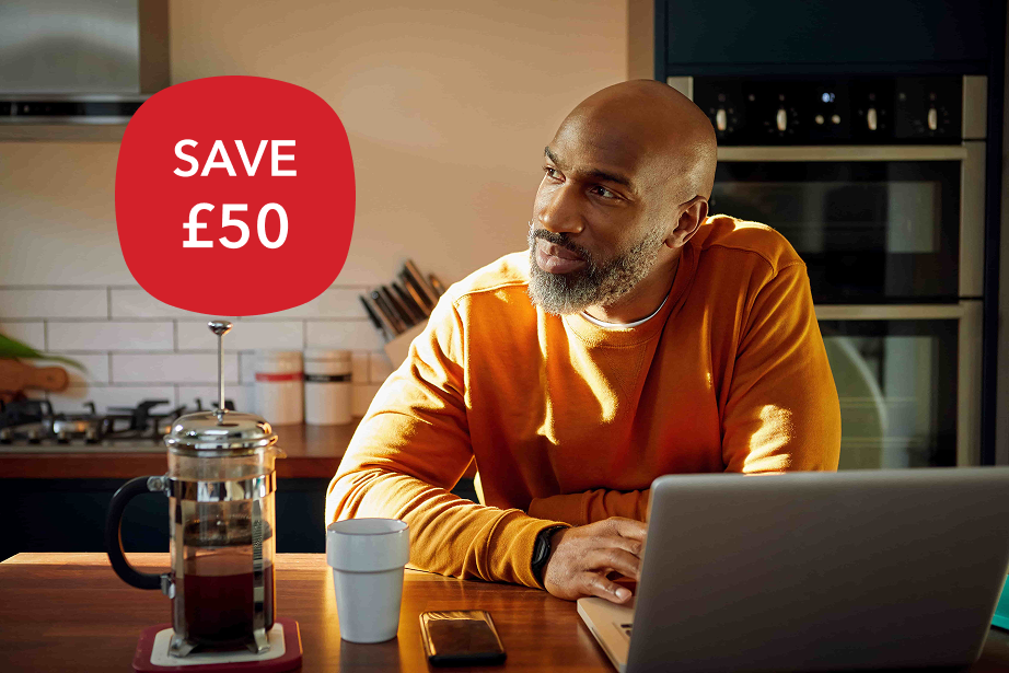 A man with a laptop thinking about making a will.