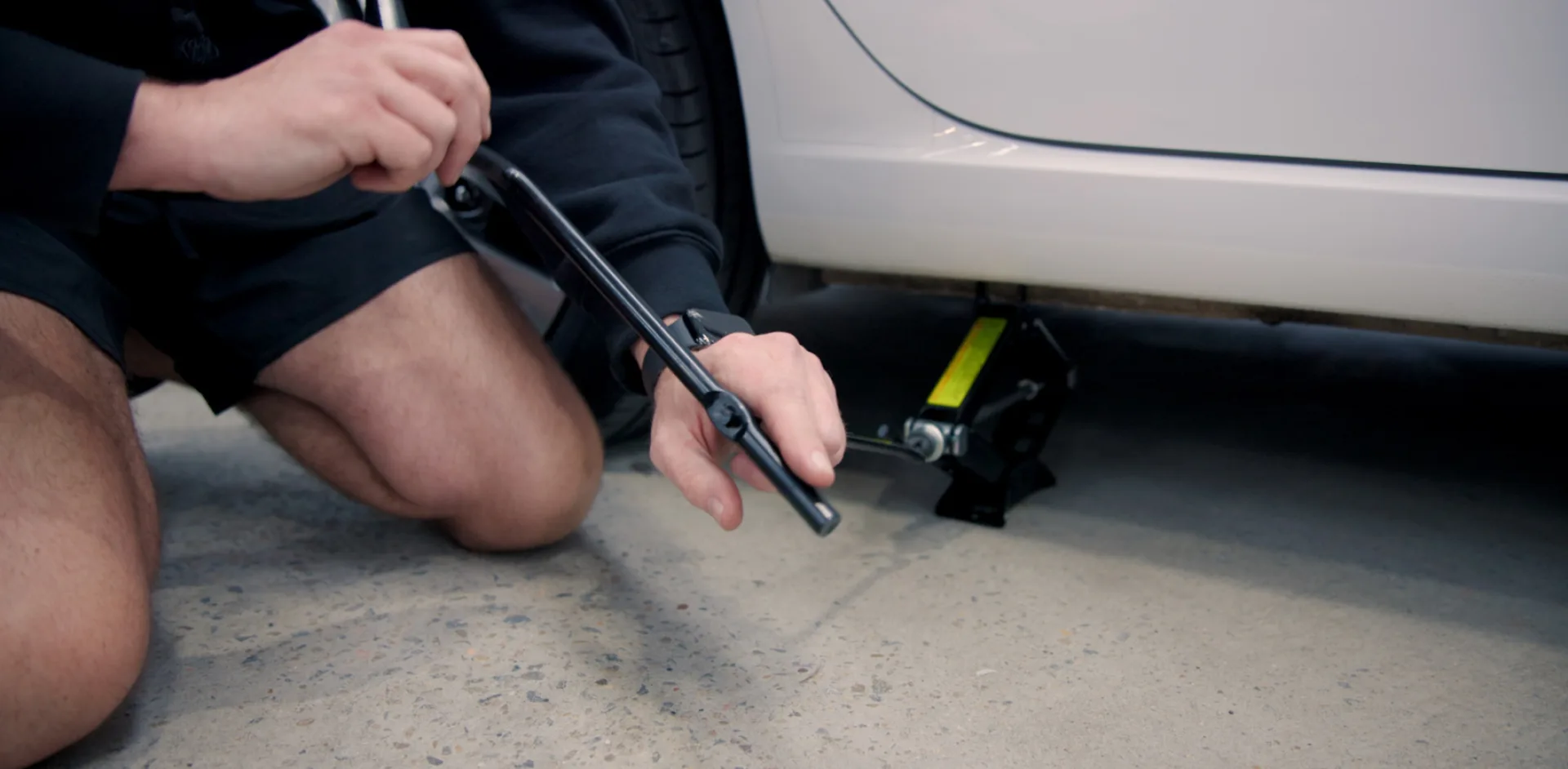 Locking a wheel brace with the cranking handle makes it easier to wind up a car jack.