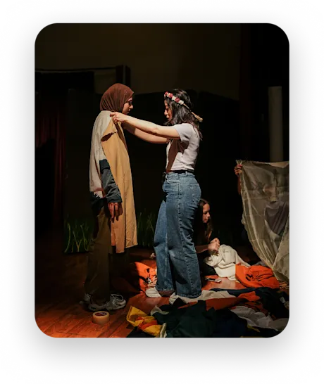 Two performers in costume backstage