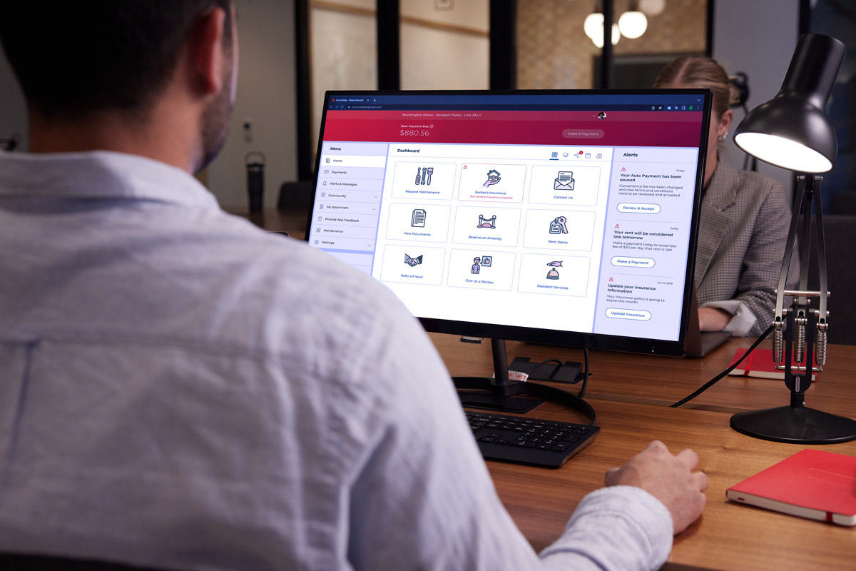 Man in office viewing resident portal on screen