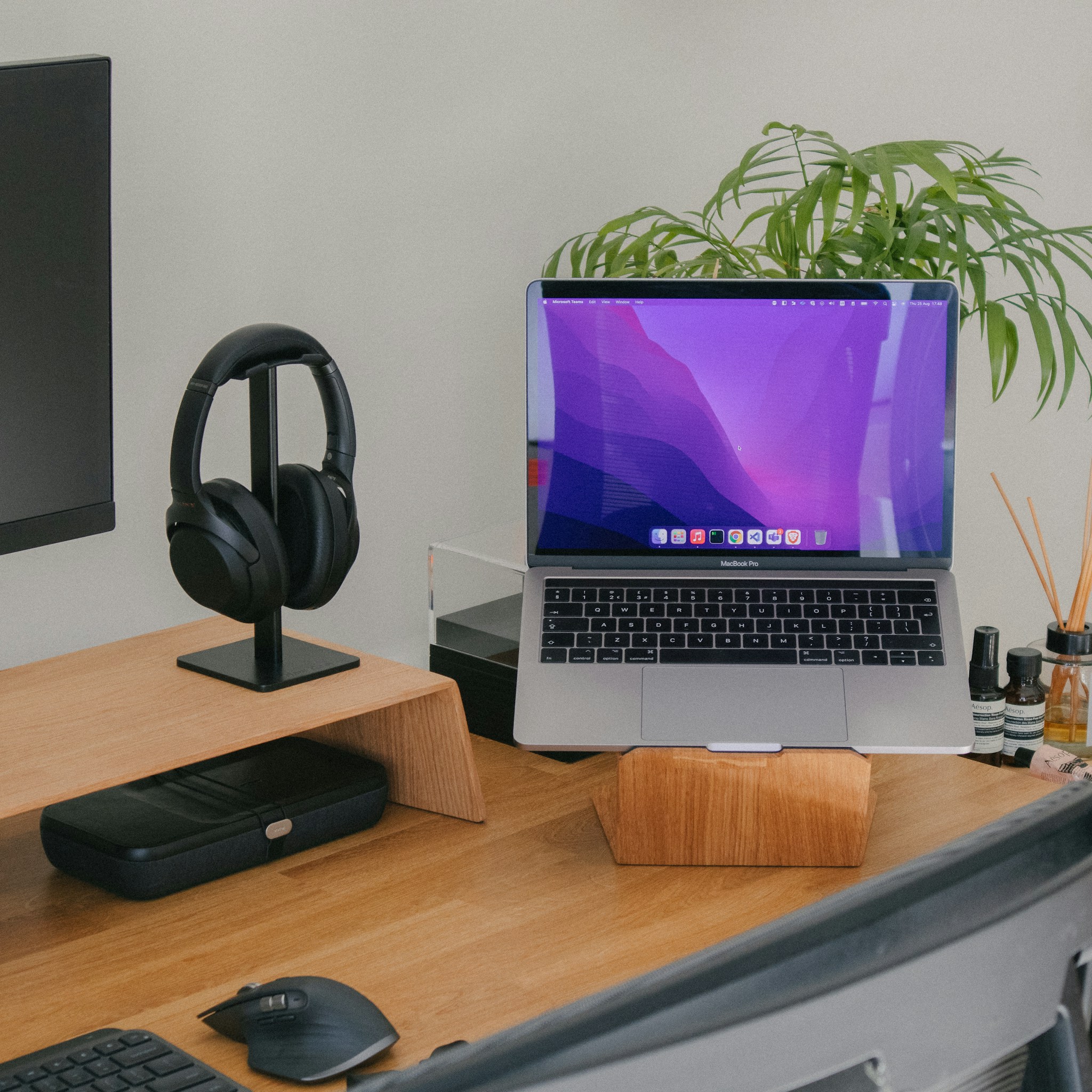 Modern office desk with a Mac Mini and multiple monitors, representing a dedicated setup.