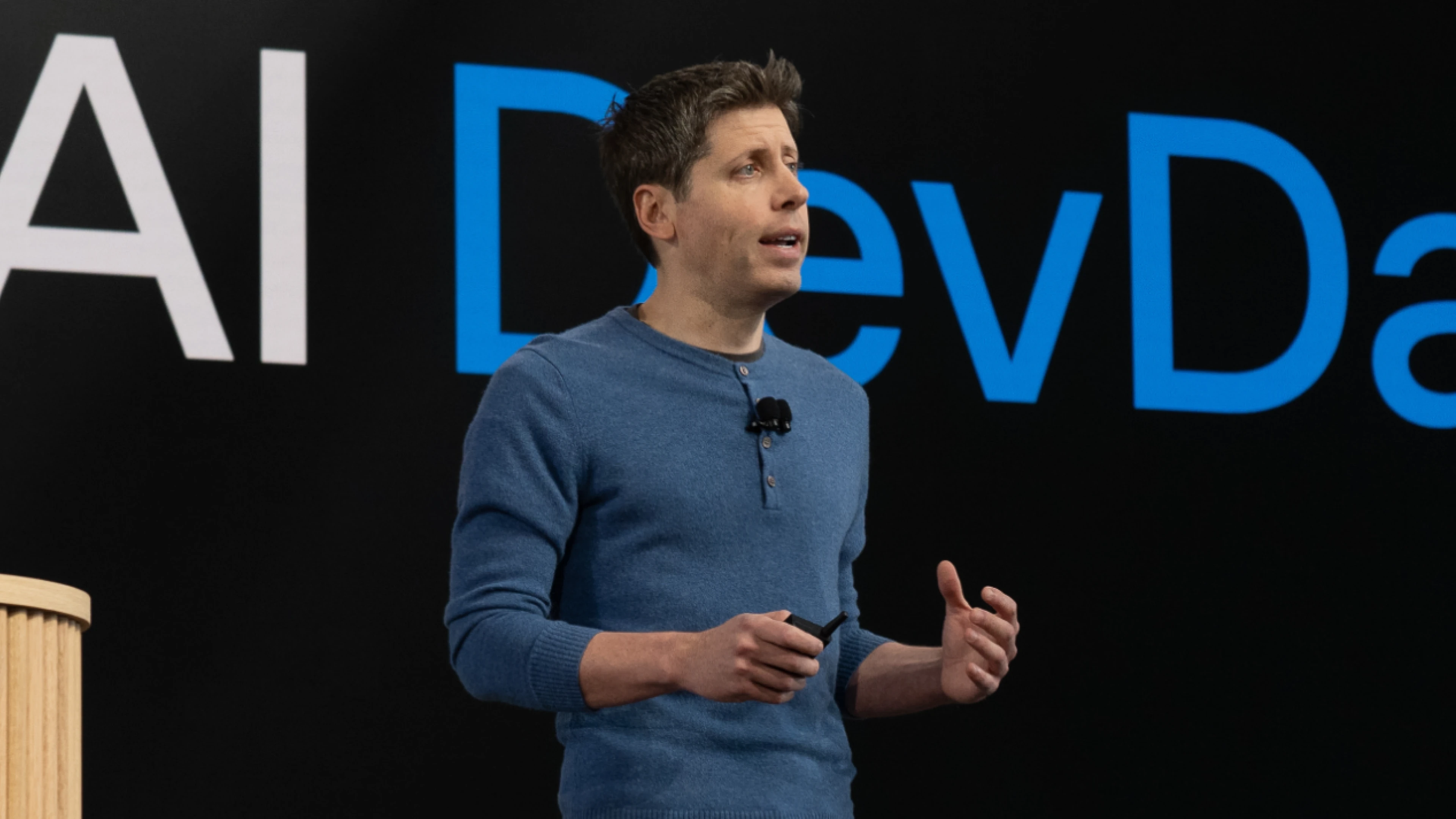 Sam Altman, CEO of OpenAI, in a professional and contemplative pose.