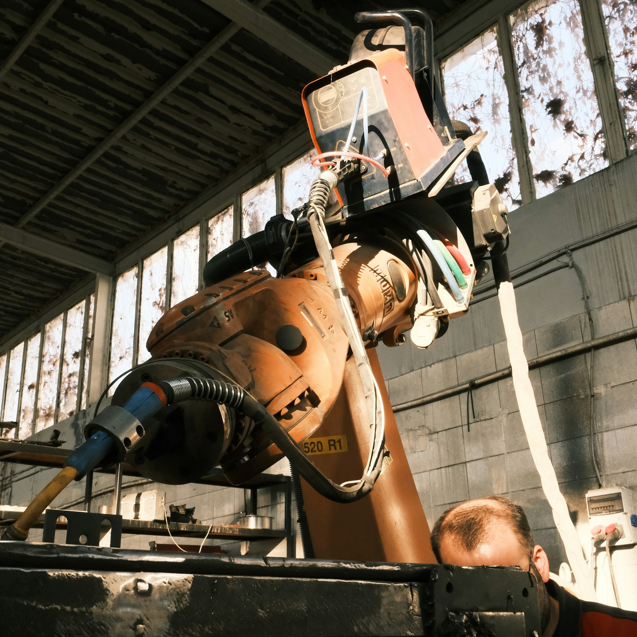 A quadruped robot navigating an industrial environment, demonstrating its utility in complex operational settings.