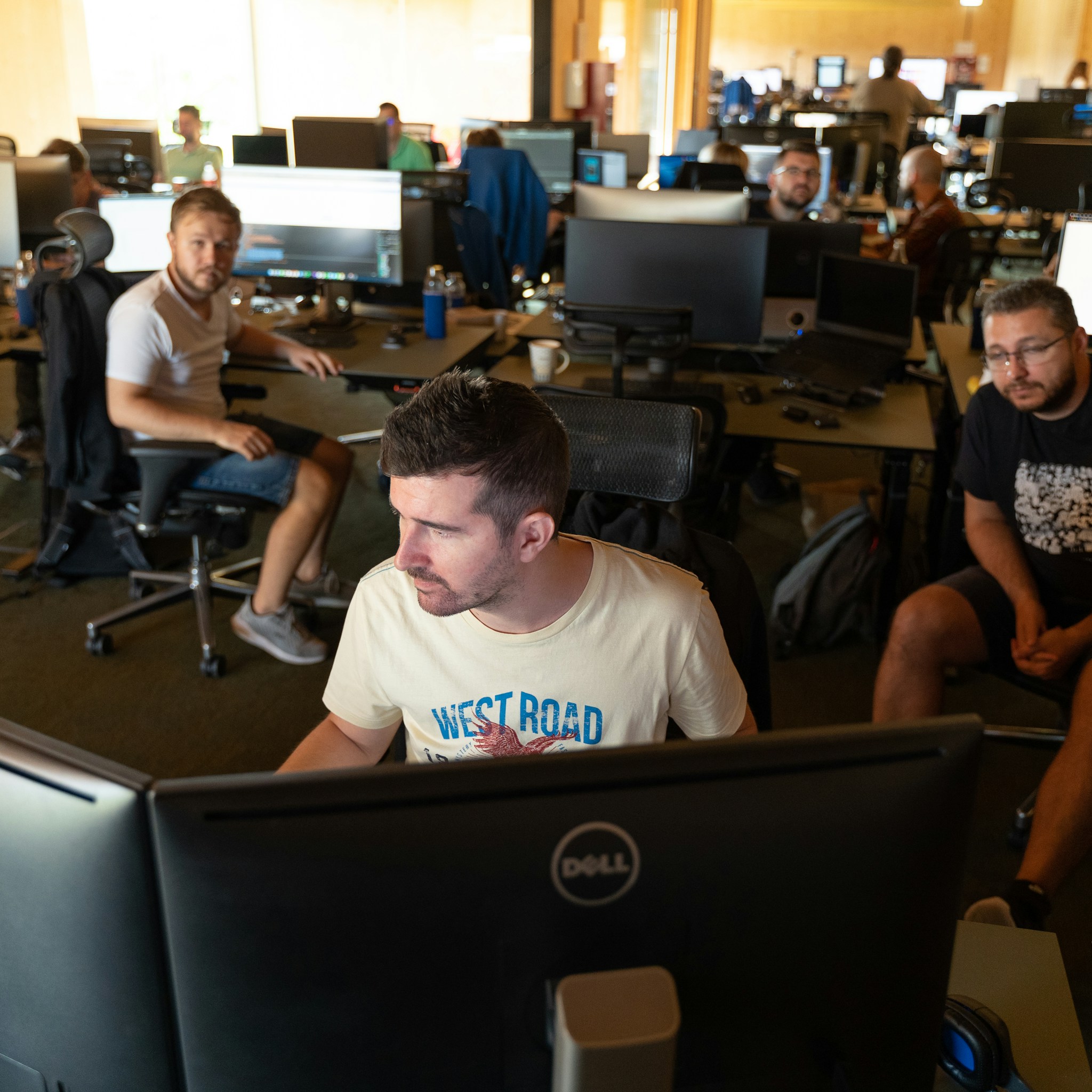 Software developers collaborating on AI projects in a modern office.