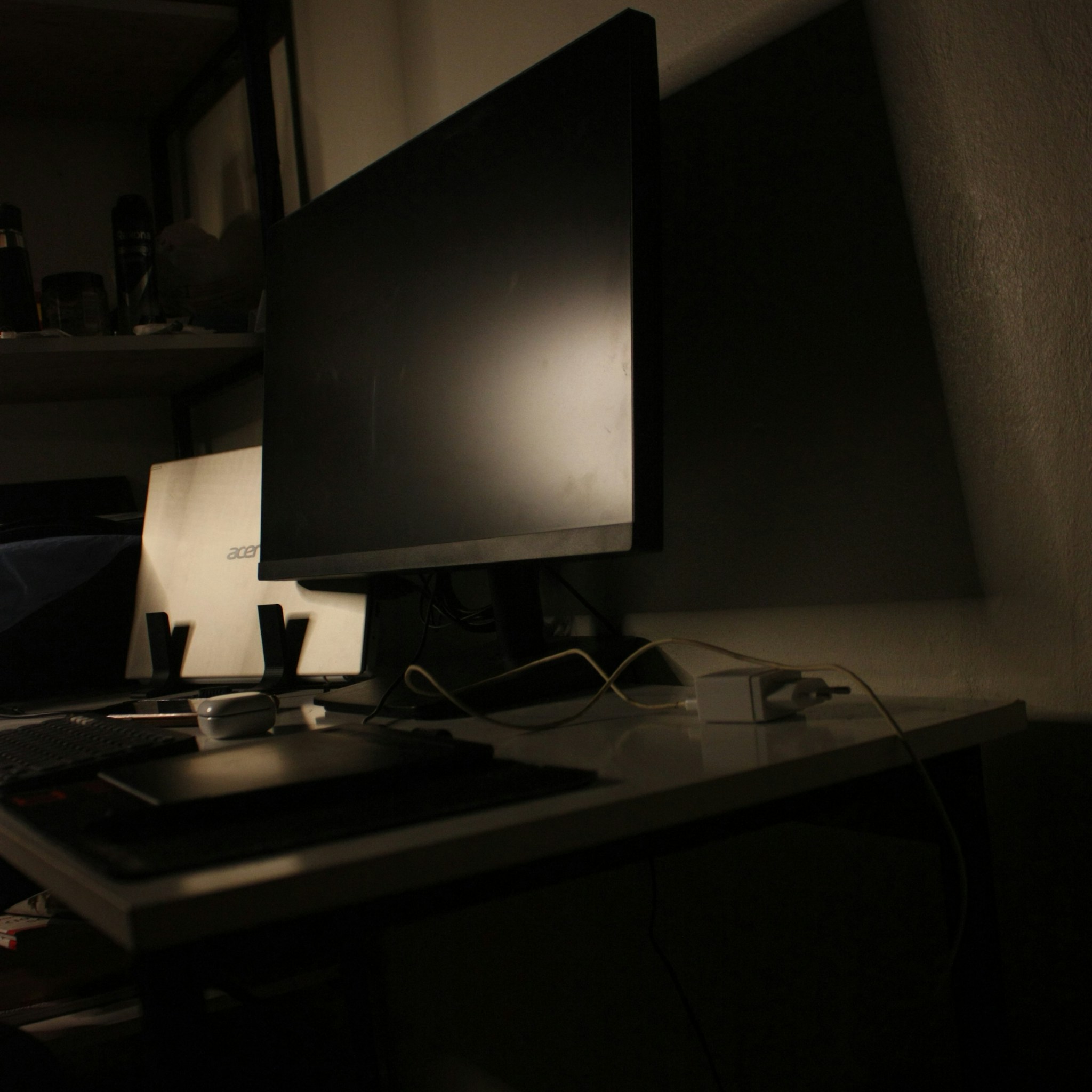 A software developer working on code across multiple monitors in a modern office setting.