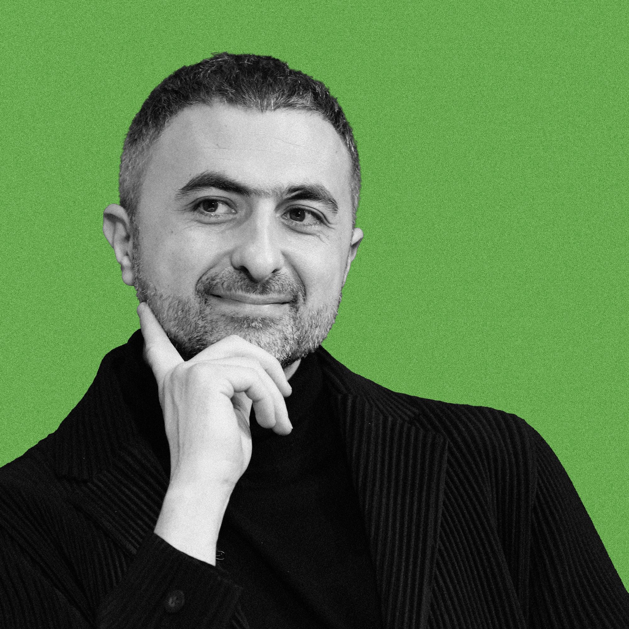 Portrait of Mustafa Suleyman, CEO of Microsoft AI, looking thoughtful.