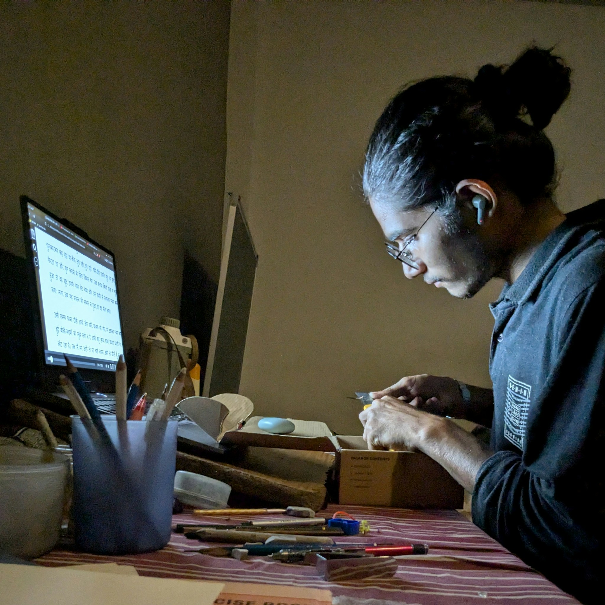 Mathematician focused on a computer screen, code visible, in a modern office setting.