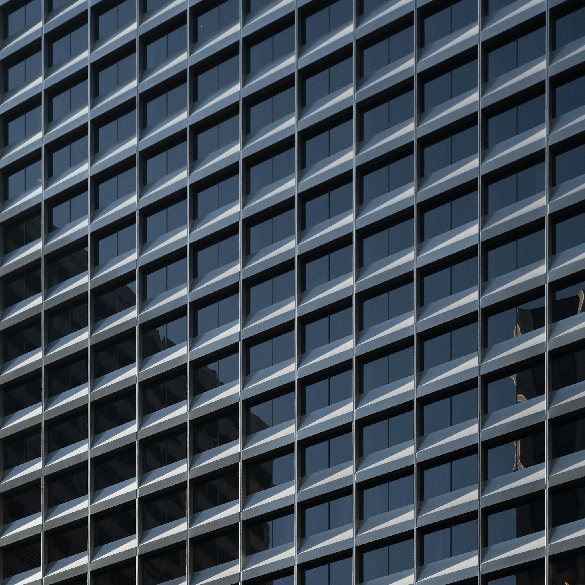 Modern high-rise office building in a bustling city, symbolizing corporate expansion.