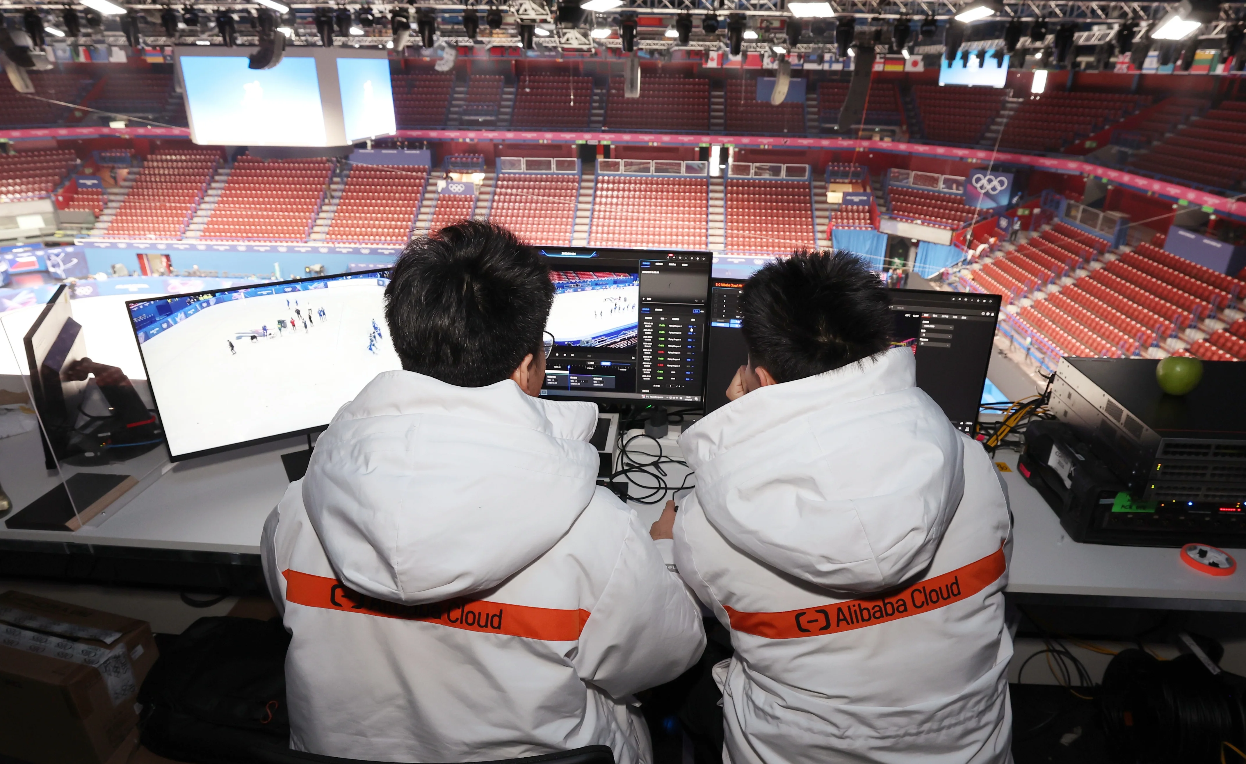 Large screen at Milan Winter Olympics venue displaying sports highlights powered by Alibaba Cloud.
