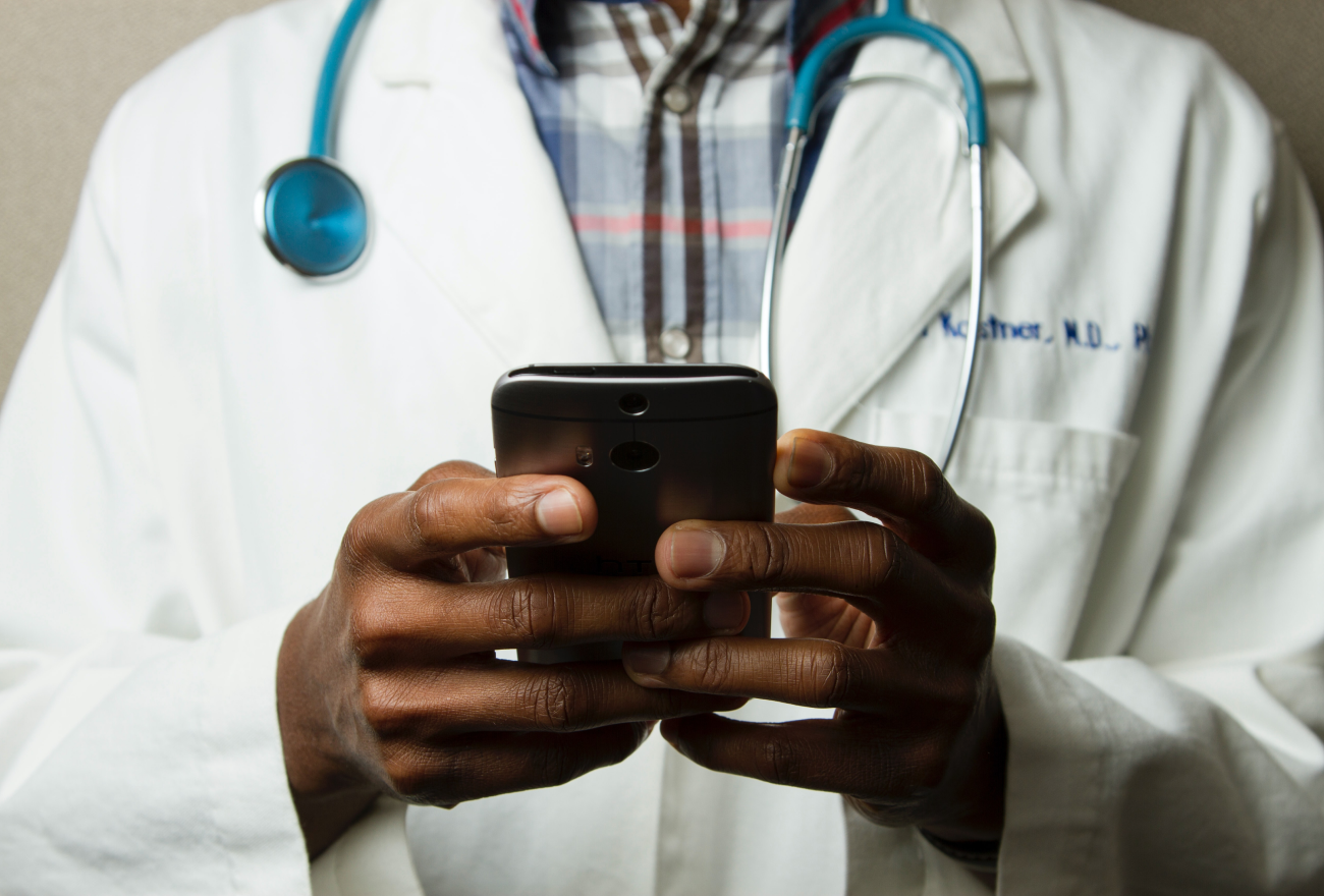 A doctor uses his mobile phone.