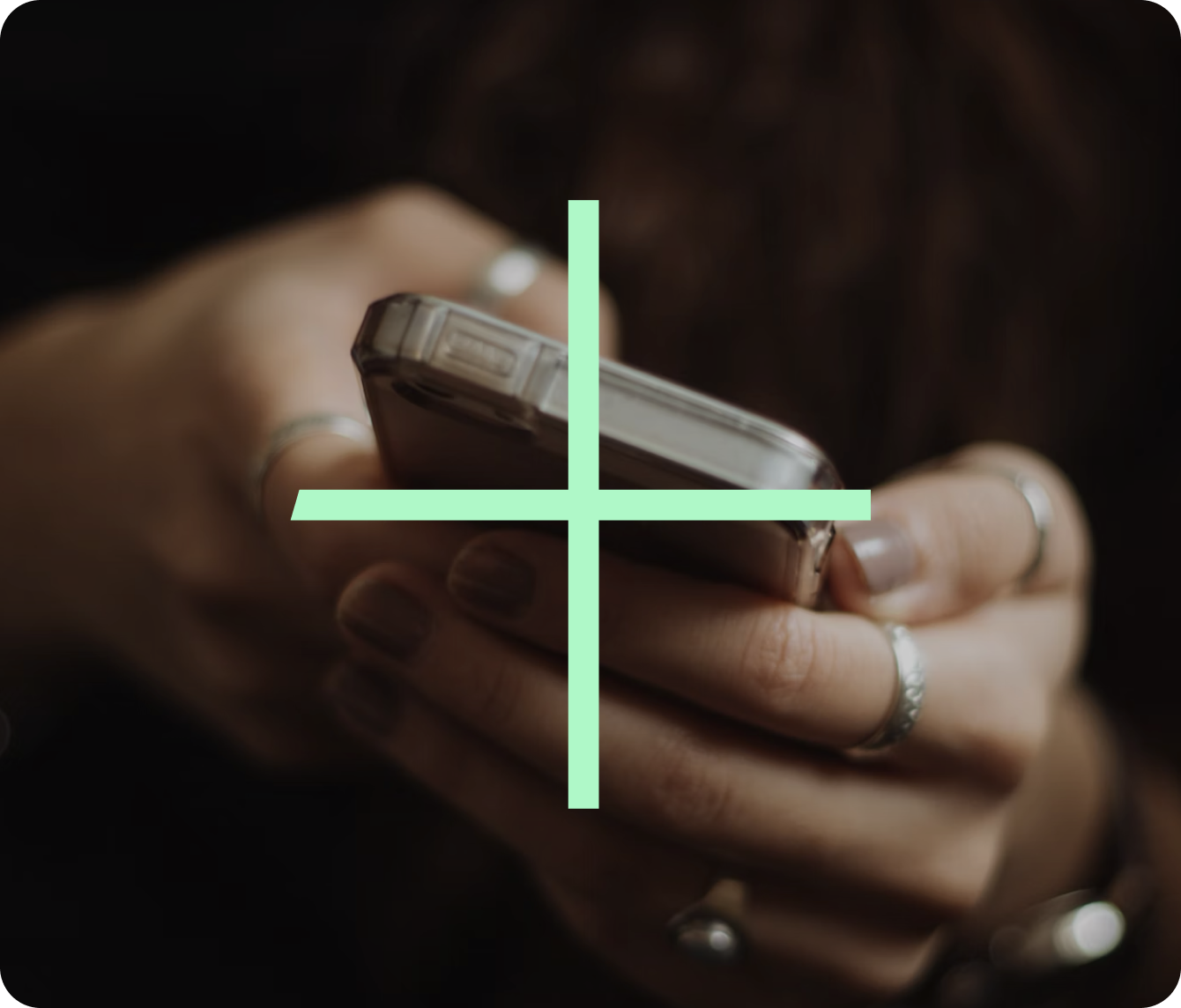 A set of hands holding a mobile phone
