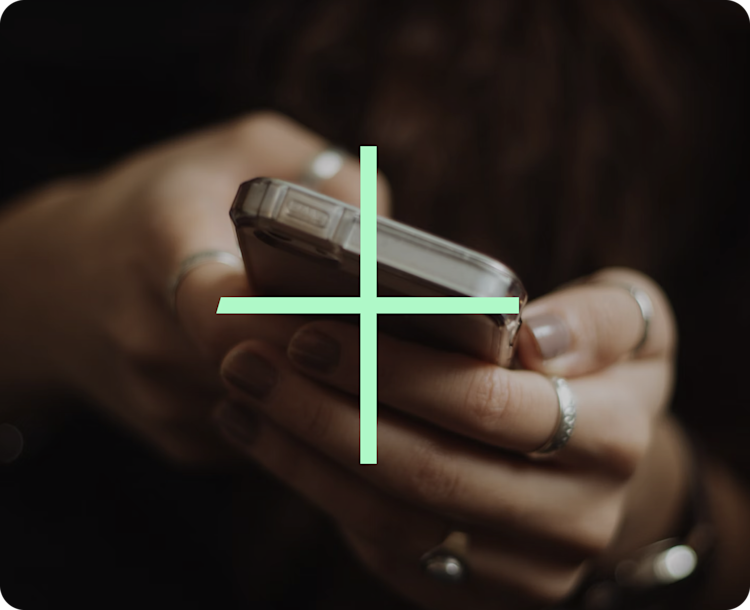 A set of hands holding a mobile phone